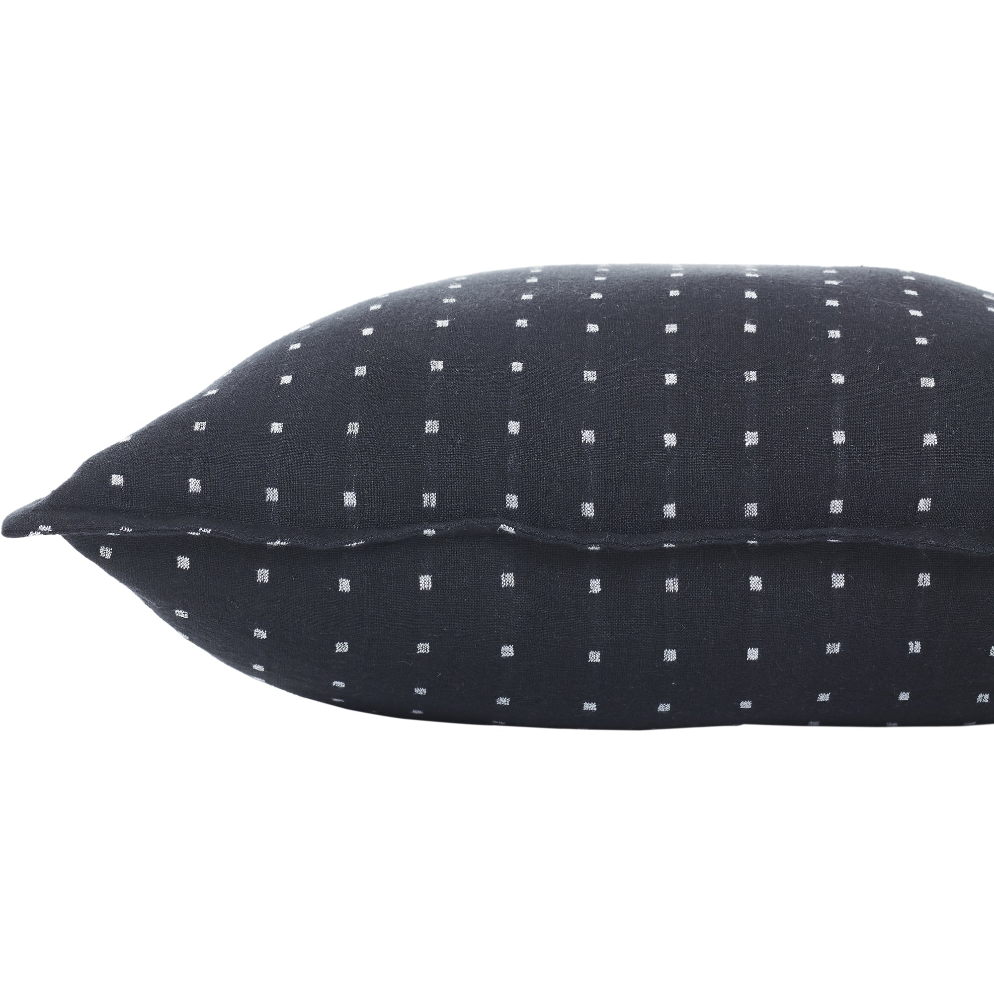 Side view of Brittany Indoor Pillow, displaying black fabric with white square design.