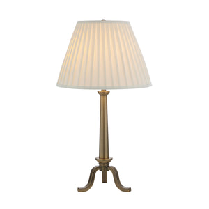 Lucerna Table Lamp featuring a lit pleated white shade and brass base