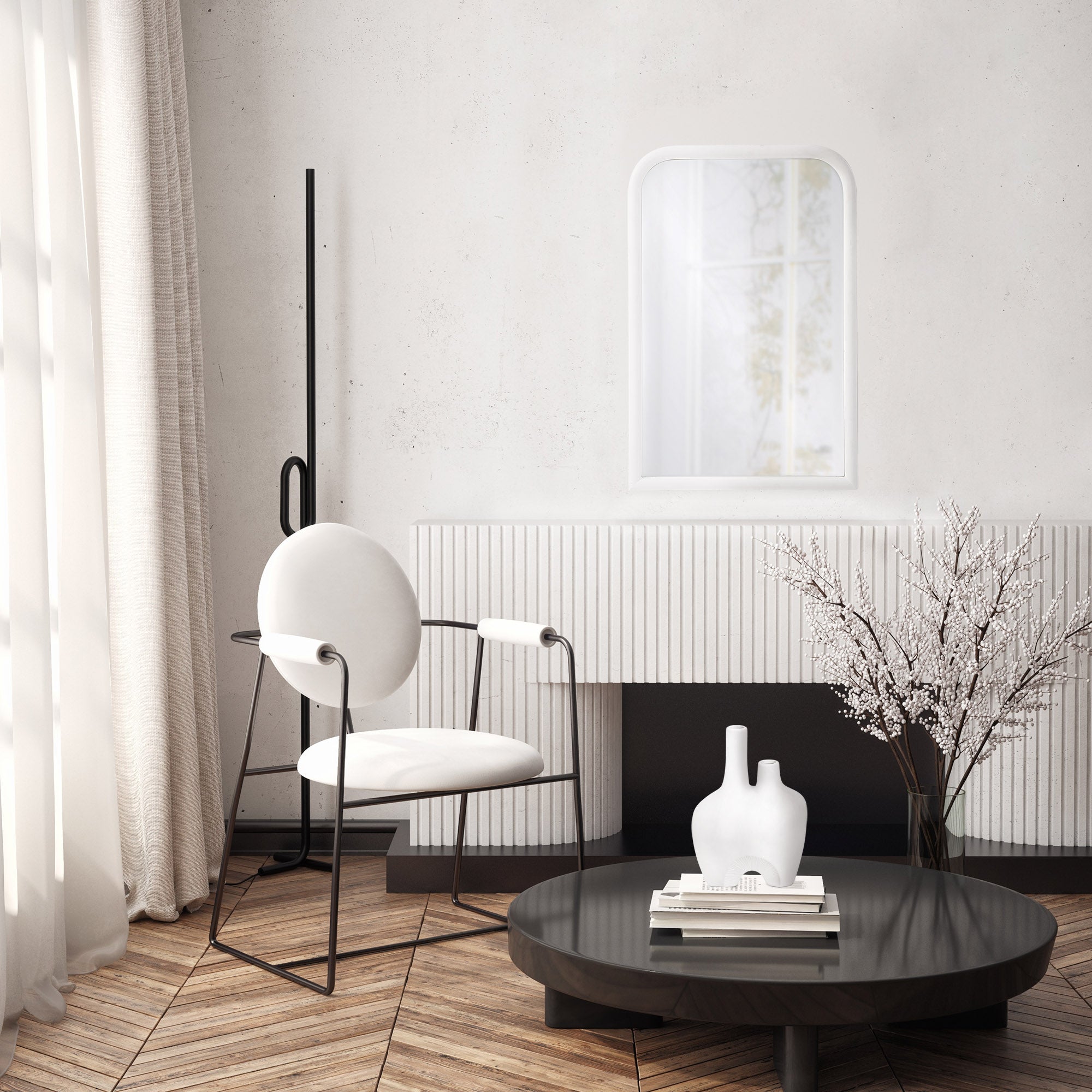Colima Wall Mirror displayed in a modern living room with a black chair and decorative vase.