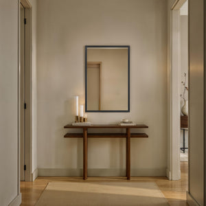 Elvas mirror displayed in a hallway above a wooden console table.