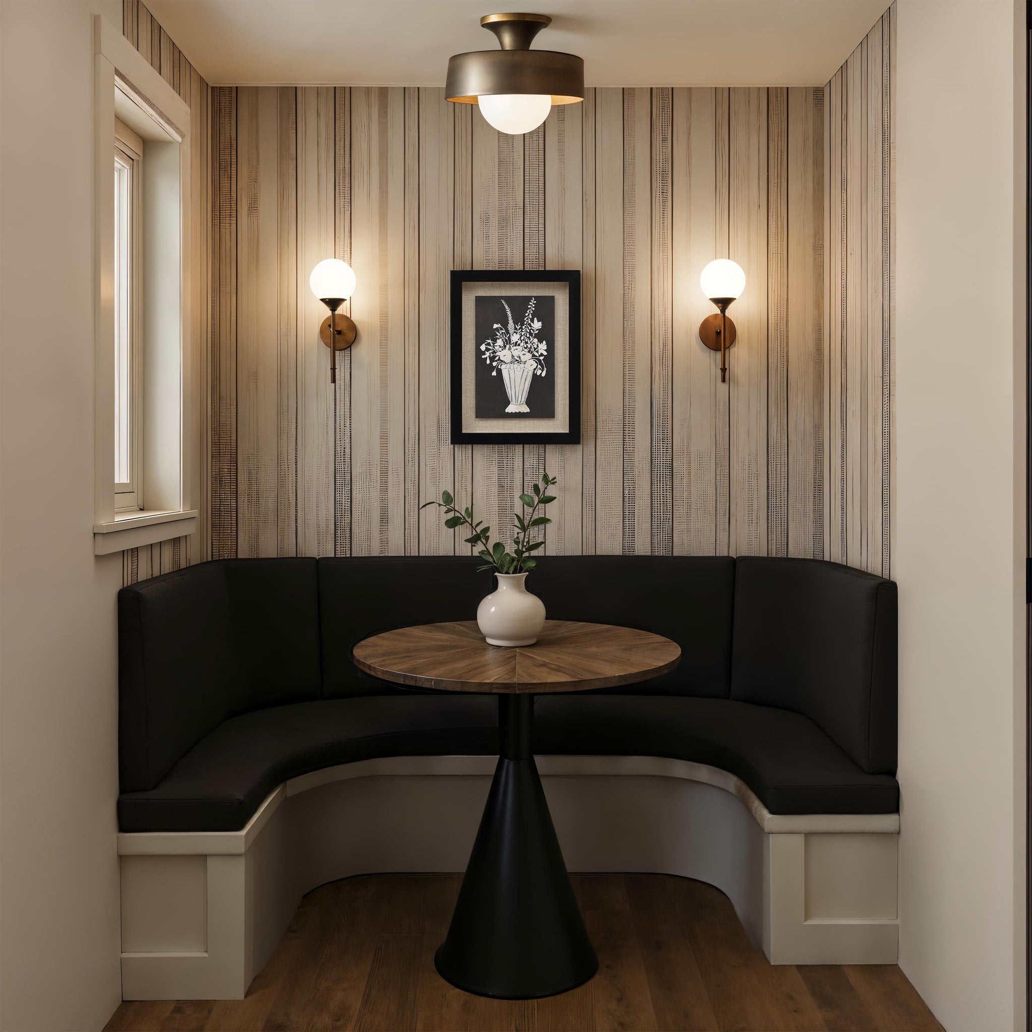 Tecoma canvas art displayed in a cozy nook with black seating and wooden table.