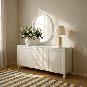 Folignio mirror displayed above a white cabinet with flowers and a lamp