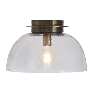Liliane Flush Mount light featuring a clear glass dome and illuminated bulb, front view.