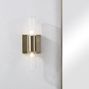 Chiara Wall Sconce mounted on a white wall, showcasing its elegant design and lighting