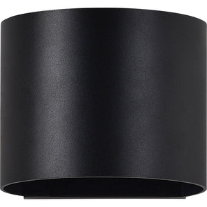 Lark Wall Sconce in matte black finish, cylindrical design with smooth surface.