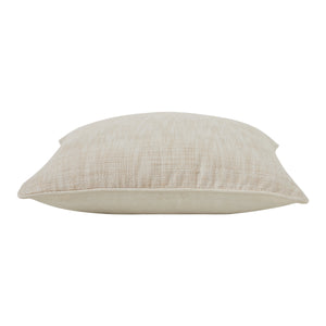 Side view of Amal indoor pillow highlighting its soft, light beige fabric.