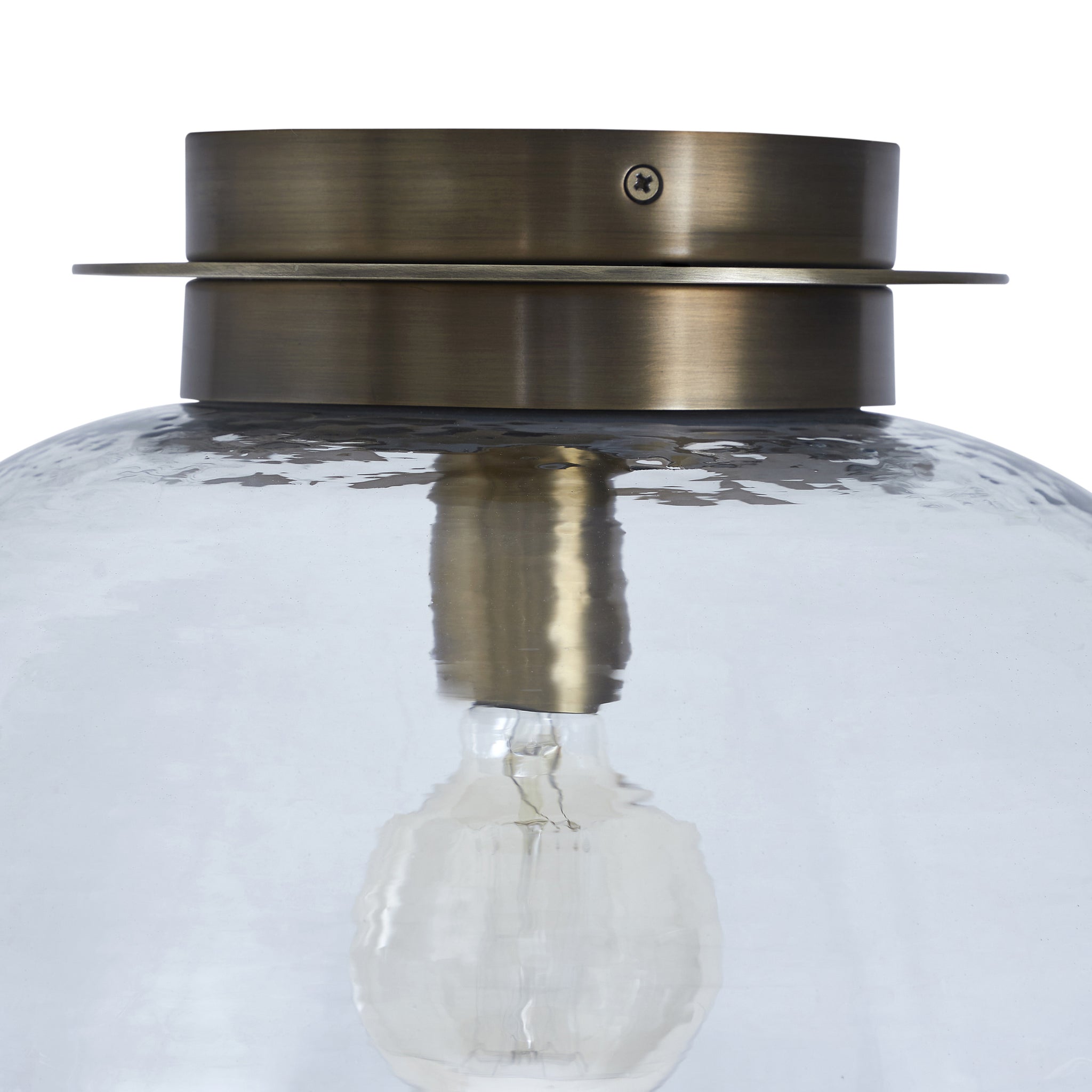 Liliane Flush Mount light showcasing a clear glass dome and brass mount, close-up view.