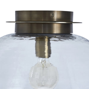 Liliane Flush Mount light showcasing a clear glass dome and brass mount, close-up view.