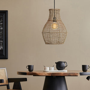 Nahanni Ceiling Fixture hanging over a dining table, showcasing its natural rattan design.