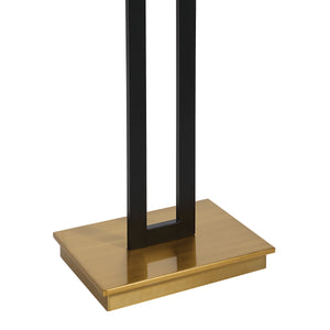 Close-up of the Theo Floor Lamp's gold base and black metal structure.