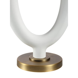 Close-up of the Aeris Table Lamp's white ceramic base with a circular cutout and a brass accent.