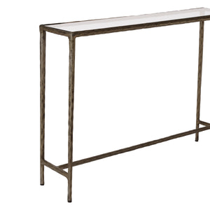 Nara console table with a white top and textured bronze legs, viewed from the side.