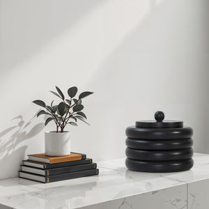 Cipher bookends by Renwil on a marble table with books and a plant.