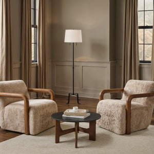Ruslur floor lamp in a cozy living room setting with two armchairs and a coffee table.