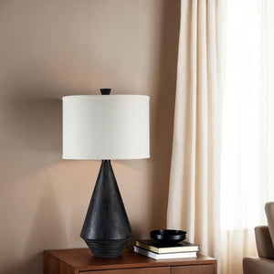 Tortora Table Lamp on a wooden side table, styled with books and a bowl.