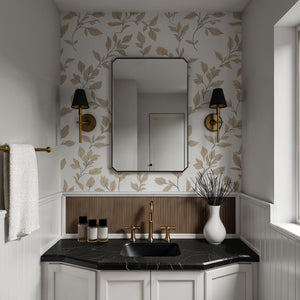 Jace mirror with a sleek black frame, reflecting a stylish bathroom with floral wallpaper and gold accents.