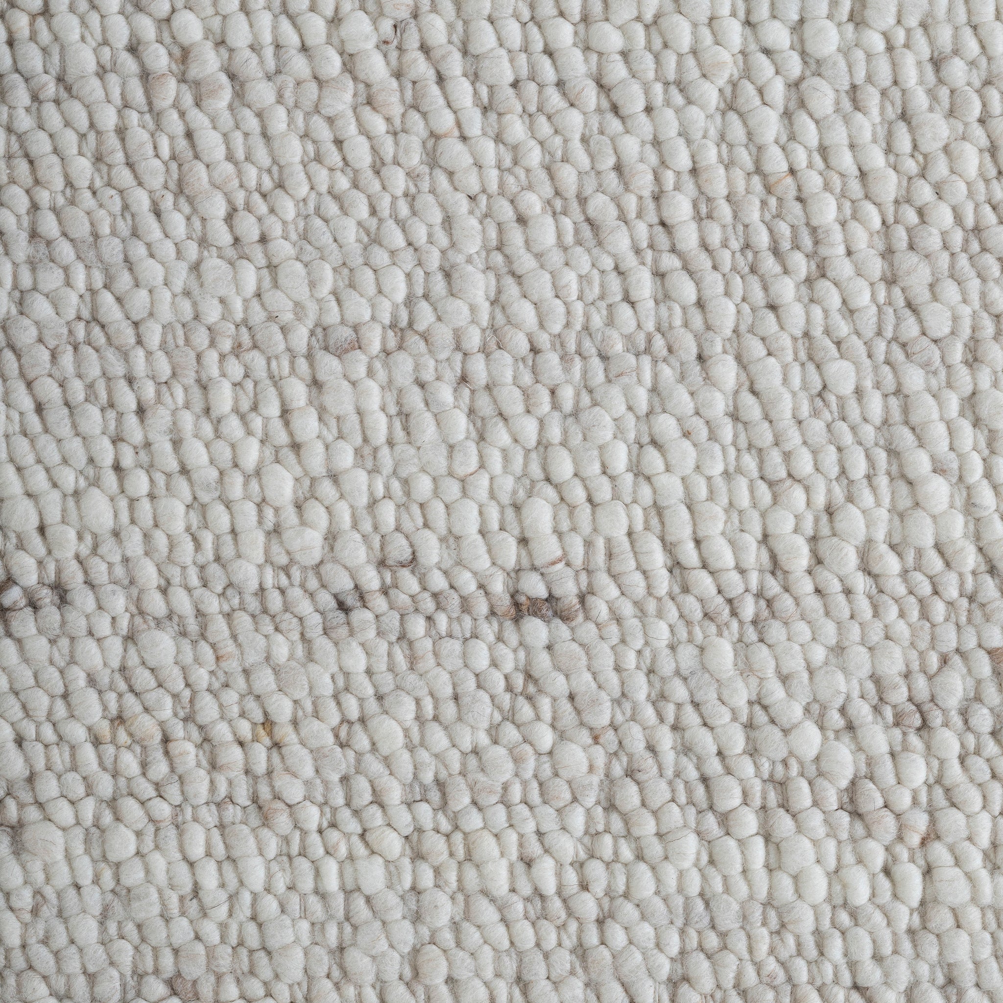 Close-up of Meghan rug showing soft, plush texture in light beige with subtle variations.