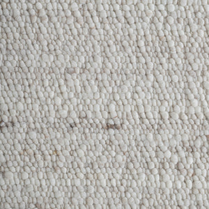 Close-up of Meghan rug texture, featuring a soft, plush surface in light beige tones.