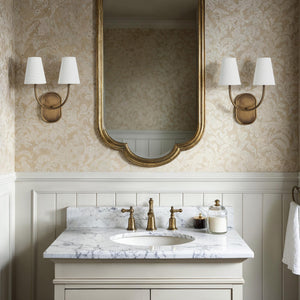 Maddie wall sconce installed in a bathroom with a marble countertop and mirror