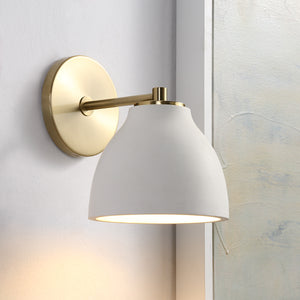 Mazia Wall Sconce installed on a wall, showing white shade and brass arm