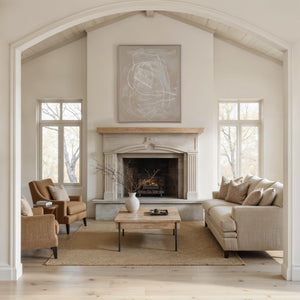Naxos canvas art displayed above a stone fireplace in a modern living room.