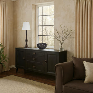 Famar Table Lamp on a dark sideboard near a window in a cozy living room setting