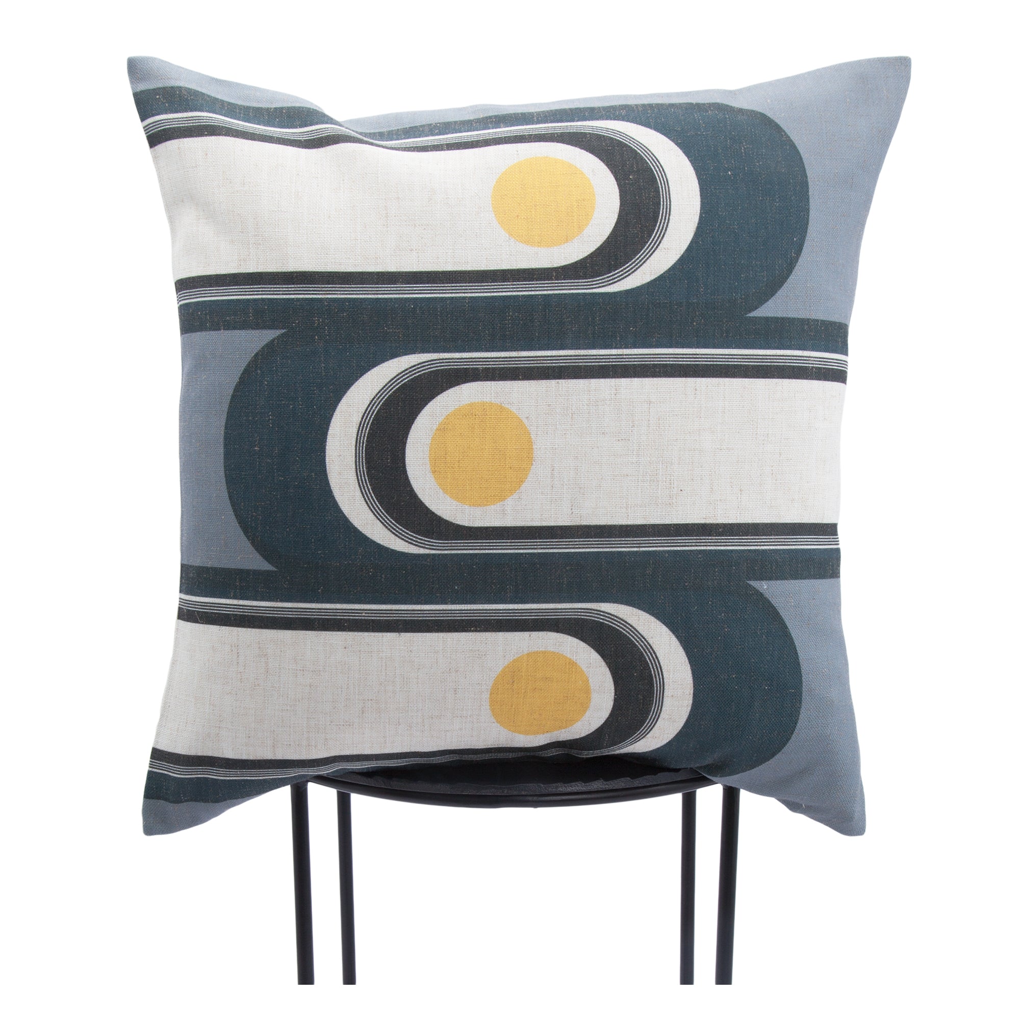 Fatima Indoor Pillow displayed on a chair, showcasing its colorful abstract pattern.