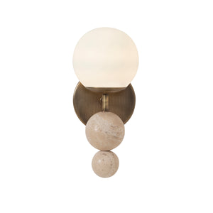 Celestia wall sconce featuring an illuminated frosted globe and beige stone spheres on a brass mount