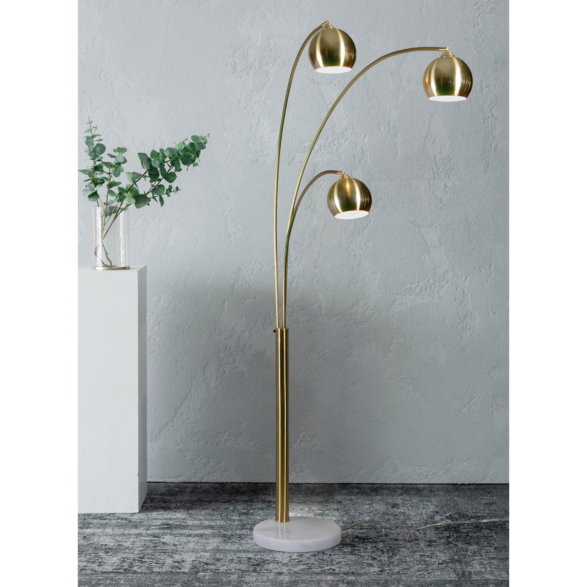 Dorset Floor Lamp in a modern setting, showcasing three brass shades and a white marble base