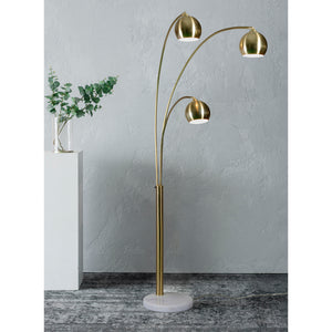 Dorset Floor Lamp in a modern setting, showcasing three brass shades and a white marble base