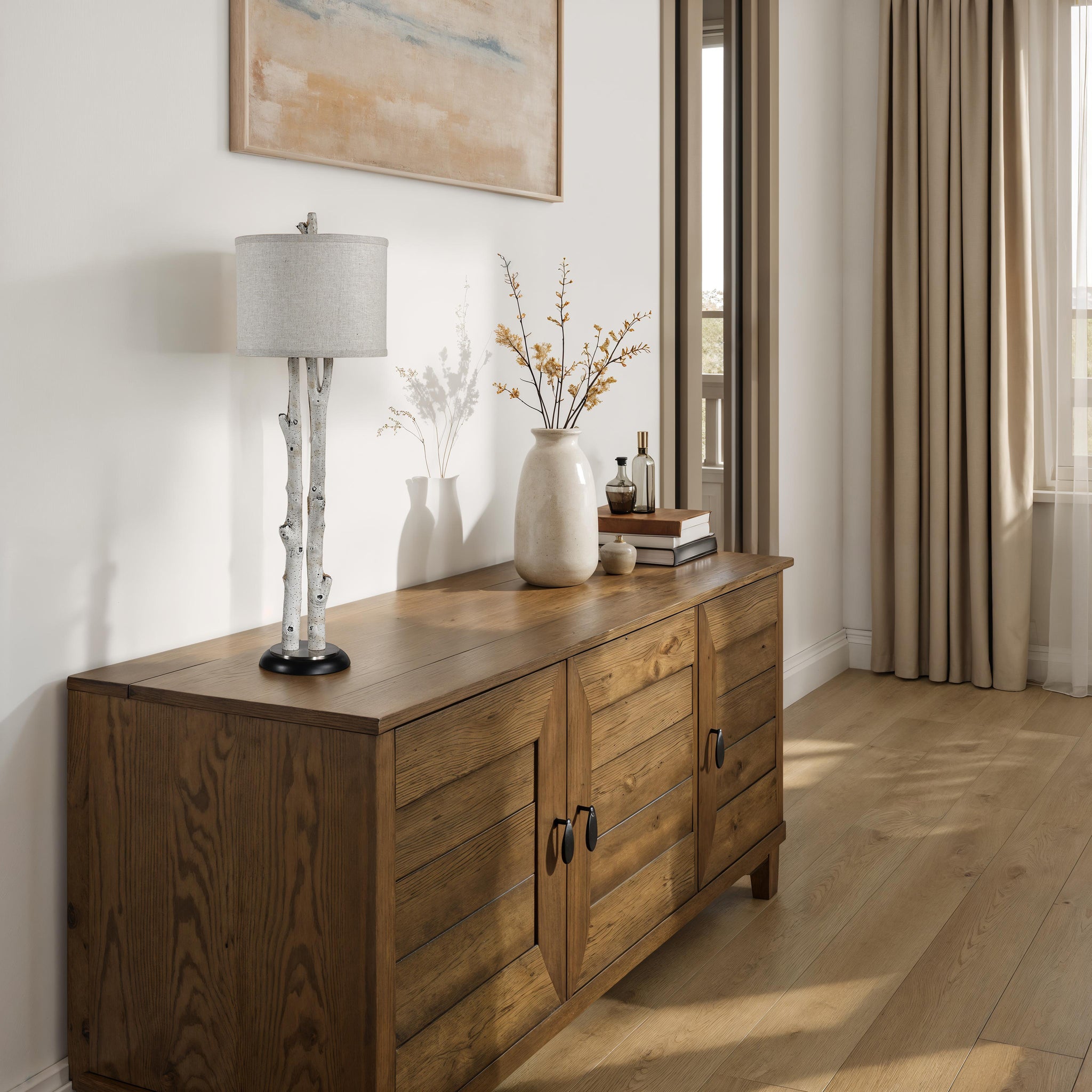 Leandro Table Lamp on a wooden cabinet with decorative items and a vase.