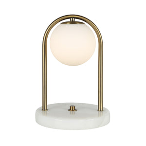 Barca table lamp featuring an illuminated frosted globe and brass arch on a white marble base.