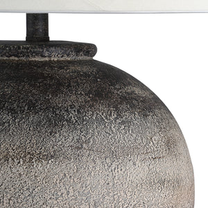 Close-up of Bronce Table Lamp's textured dark gray ceramic base and white shade