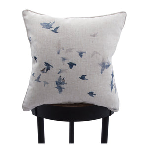 Flight indoor pillow with a bird design, displayed on a black stool.
