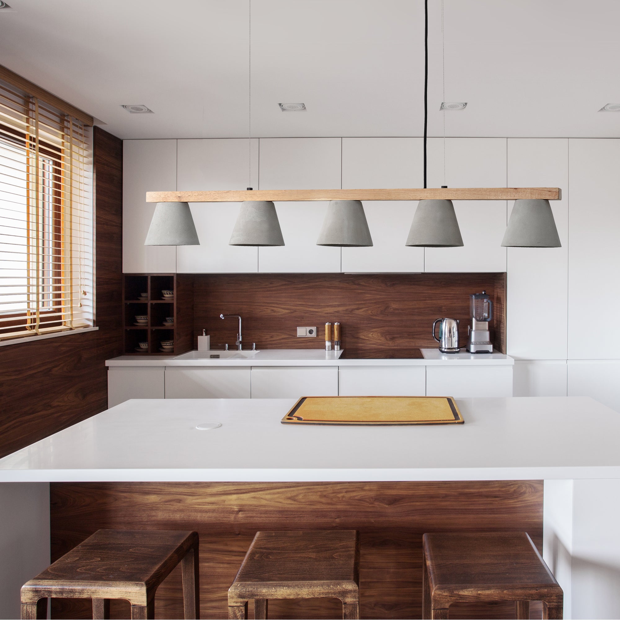 Zain Ceiling Fixture installed in a modern kitchen, featuring gray concrete shades above a white countertop.