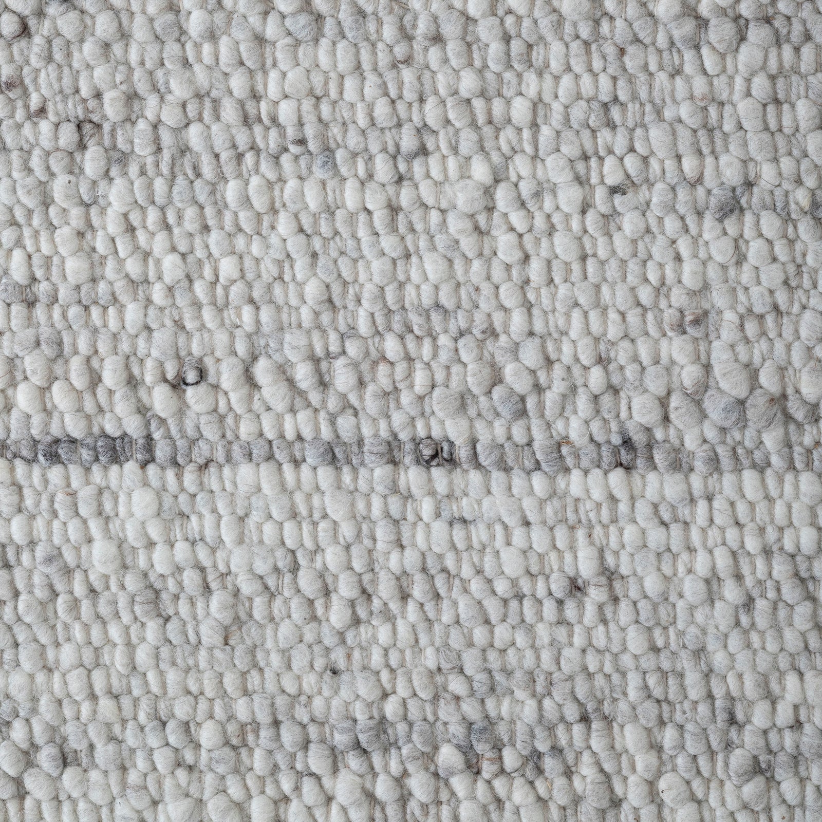 Meghan rug by Renwil, light gray woven texture with subtle patterns, rectangular shape.