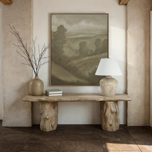 Heritage table lamp on a rustic wooden table with a landscape painting and a beige vase.