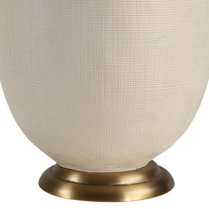 Close-up of Cartagena Table Lamp showing the textured off-white ceramic base and brass foot