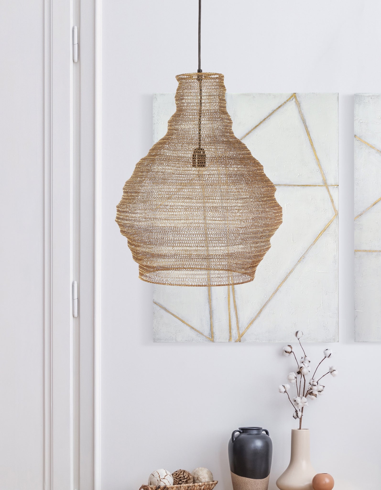 Gere Ceiling Fixture chandelier hanging in a modern interior with abstract art