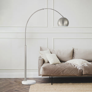 Aglow floor lamp positioned next to a cozy sofa in a stylish living room.