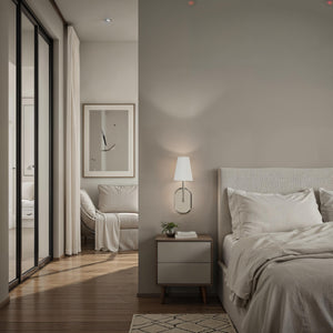 Annona wall sconce illuminating a modern bedroom with neutral decor.