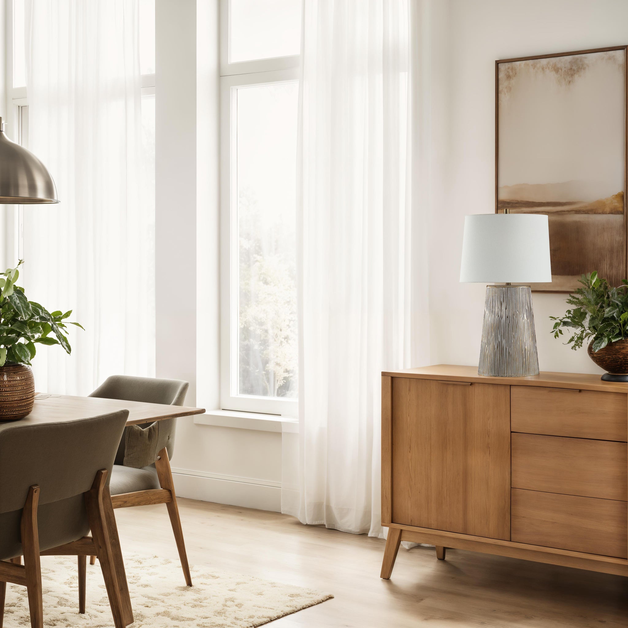 Calma Table Lamp placed on a wooden sideboard in a bright room