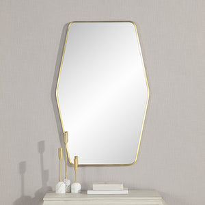 Mocha Wall Mirror displayed on a wall with decorative items on a table below