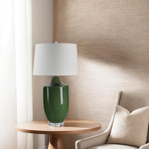 Pesca Table Lamp on a wooden table beside a beige chair and textured wall