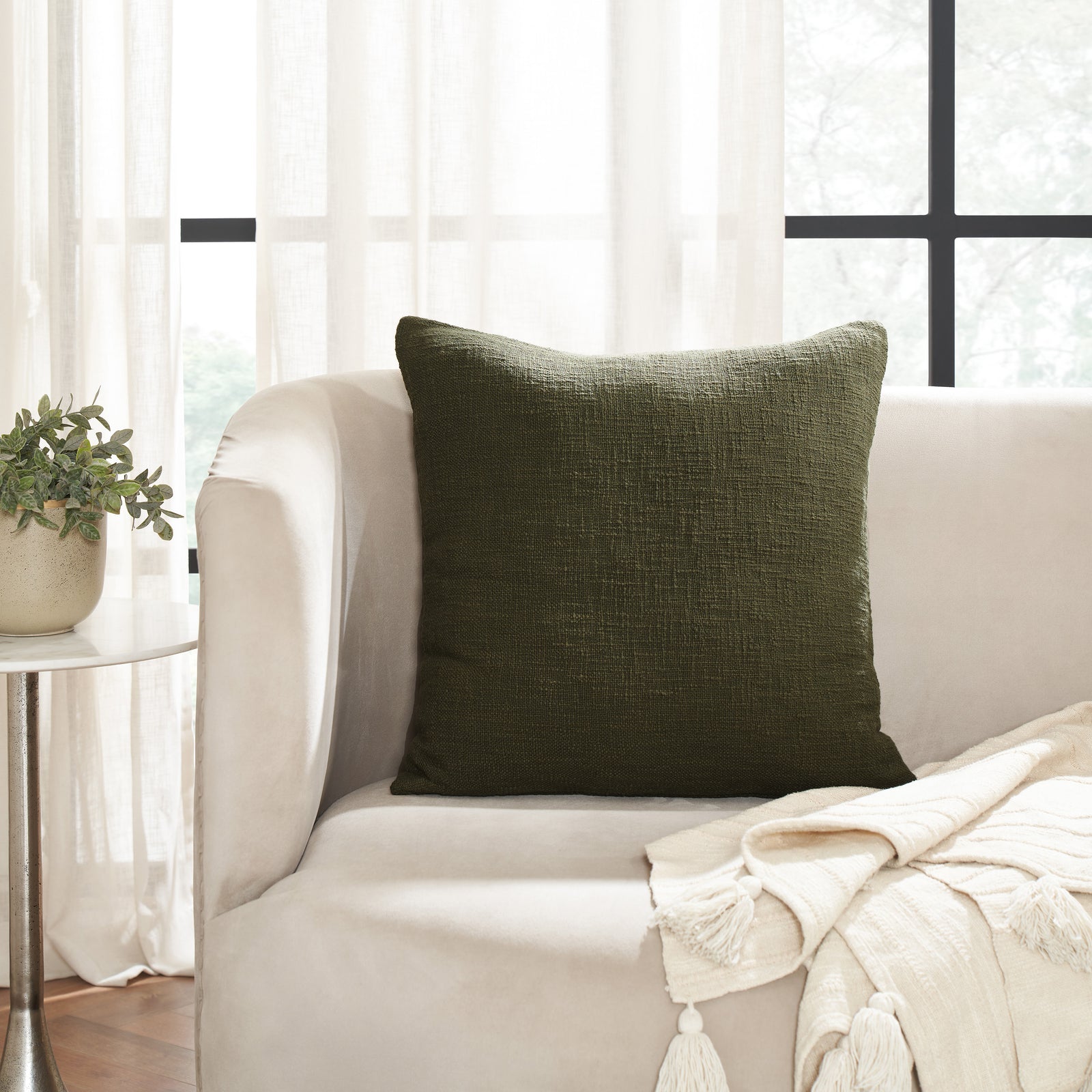 Sandro indoor pillow in dark green with a textured fabric surface.
