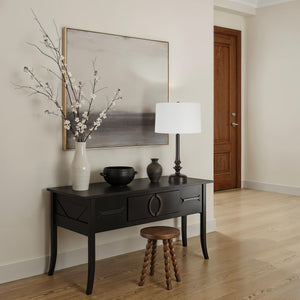 Zyra Table Lamp on a black console table with decorative vase and artwork, modern decor.