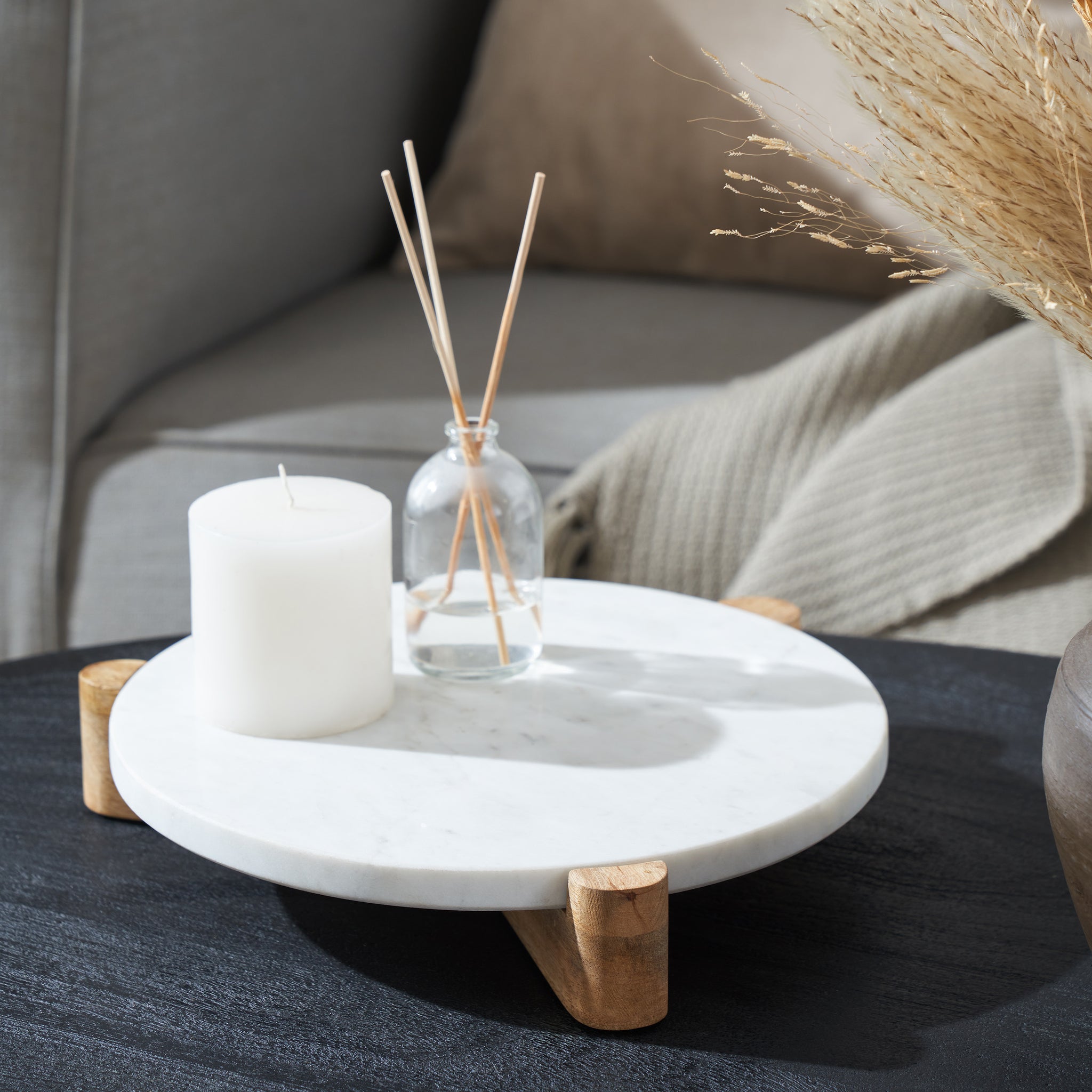Lance marble tray styled with a candle and diffuser, round white marble top, wooden legs.