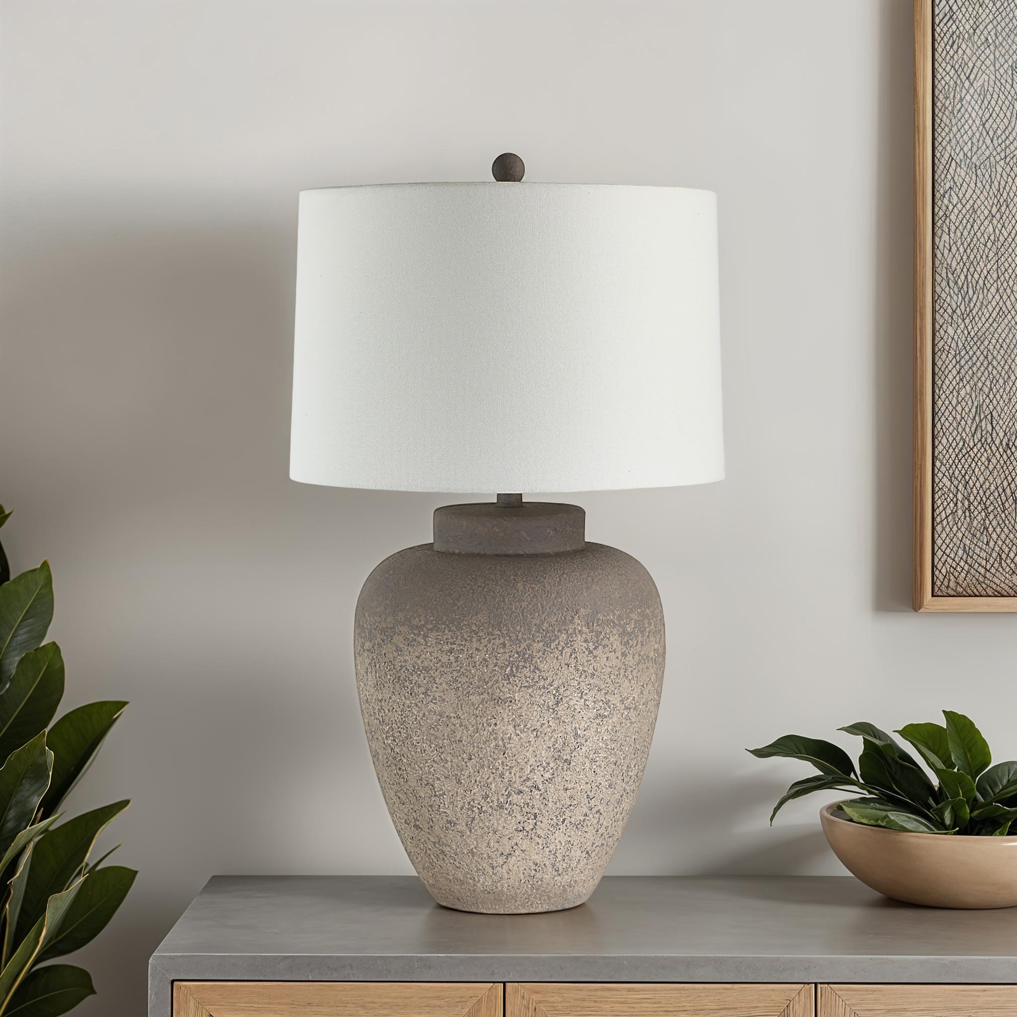 Lattuga table lamp on a modern side table with plants and artwork in the background