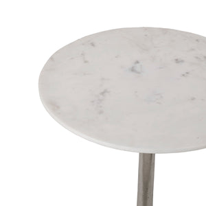 Eloa round table with a white marble top and a sleek metal base, showcasing a minimalist design.