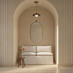 Hudson mirror by Renwil displayed in a modern interior, above a beige sofa.